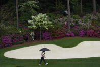 Justin Rose, of England, walks in the rain to the 13th green during the third round of the Masters golf tournament on Saturday, April 10, 2021, in Augusta, Ga. (AP Photo/Gregory Bull)