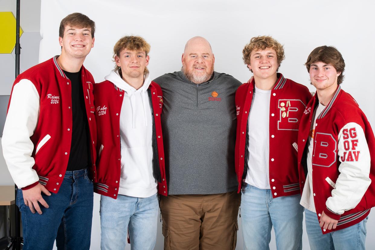 (From left) Bermudian Springs basketball players Austin Reinert, Gabe Kline, coach Jared Nace, Tyson Carpenter and Ethan Young pose for a group photo during YAIAA winter sports media days Thursday, November 9, 2023, in York.