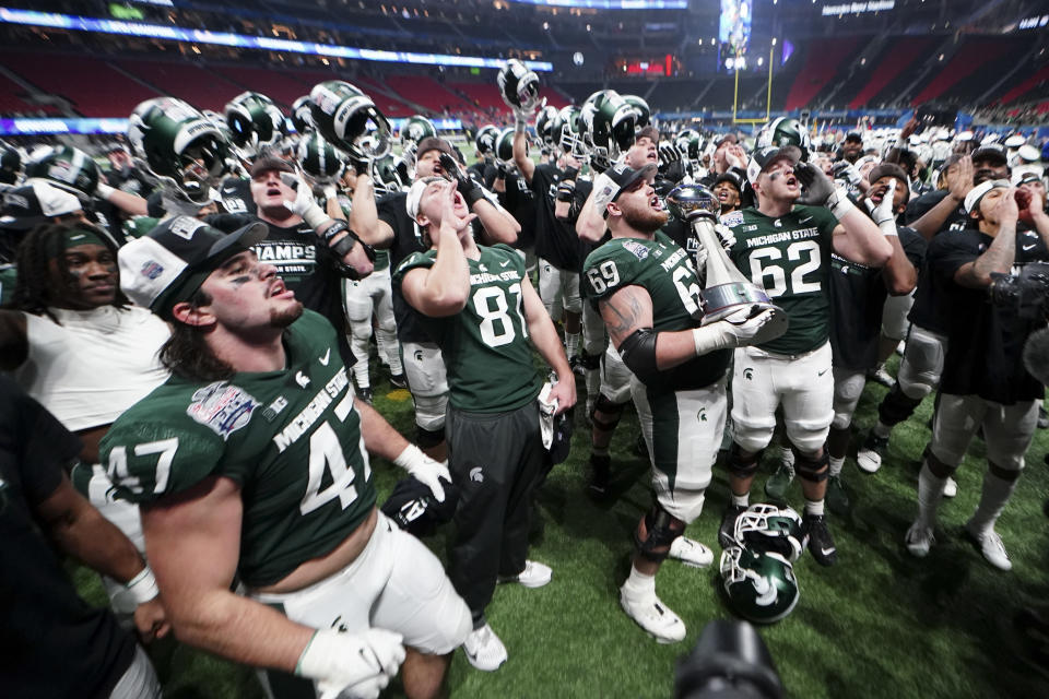 Michigan State players celebrate after the Peach Bowl NCAA college football game against Pittsburgh, Thursday, Dec. 30, 2021, in Atlanta. Michigan State won 31-21.(AP Photo/John Bazemore)
