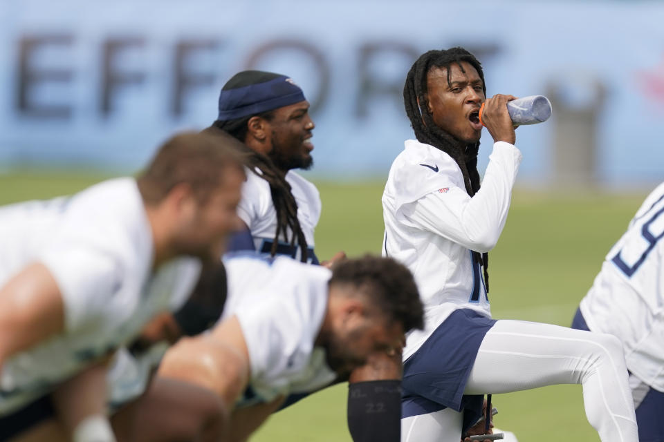 Tennessee Titans wide receiver DeAndre Hopkins, right, takes a drink during an NFL football training camp practice Wednesday, July 26, 2023, in Nashville, Tenn. (AP Photo/George Walker IV)