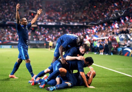 French defender Adil Rami (C) is congratulated by teammates after scoring a goal during the friendly football match France vs Iceland at the Hainaut Stadium in the French northern city of Valenciennes