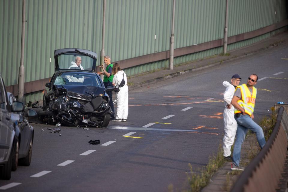 Police officers and forensic experts secure evidences at the site where a motorcycle crashed with a car, probably the car used by an alleged offender to cause several accidents on the A 100 highway in Berlin on August 19, 2020. - A man caused a series of motorway accidents in Berlin on Tuesday night, injuring six people including three seriously in what German prosecutors have described as an Islamist act. (Photo by Odd ANDERSEN / AFP) (Photo by ODD ANDERSEN/AFP via Getty Images)