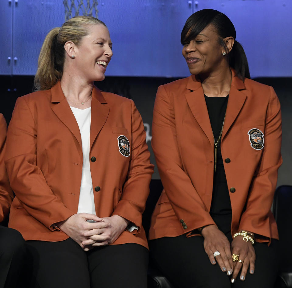 Basketball Hall of Fame inductees Katie Smith left, and Tina Thompson, smile as they sit together during a news conference at the Naismith Memorial Basketball Hall of Fame, Thursday, Sept. 6, 2018, in Springfield, Mass. (AP Photo/Jessica Hill)