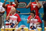 <p>Competitive eater’s Miki Sudo (L) and Sonya Thomas swallow hot dogs during the Women’s Nathan’s Famous Fourth of July International Hot-dog eating contest in Coney Island, New York on July 4, 2017. Sudo won by consuming 41 hotdogs. (Peter Foley/EPA/Shutterstock) </p>