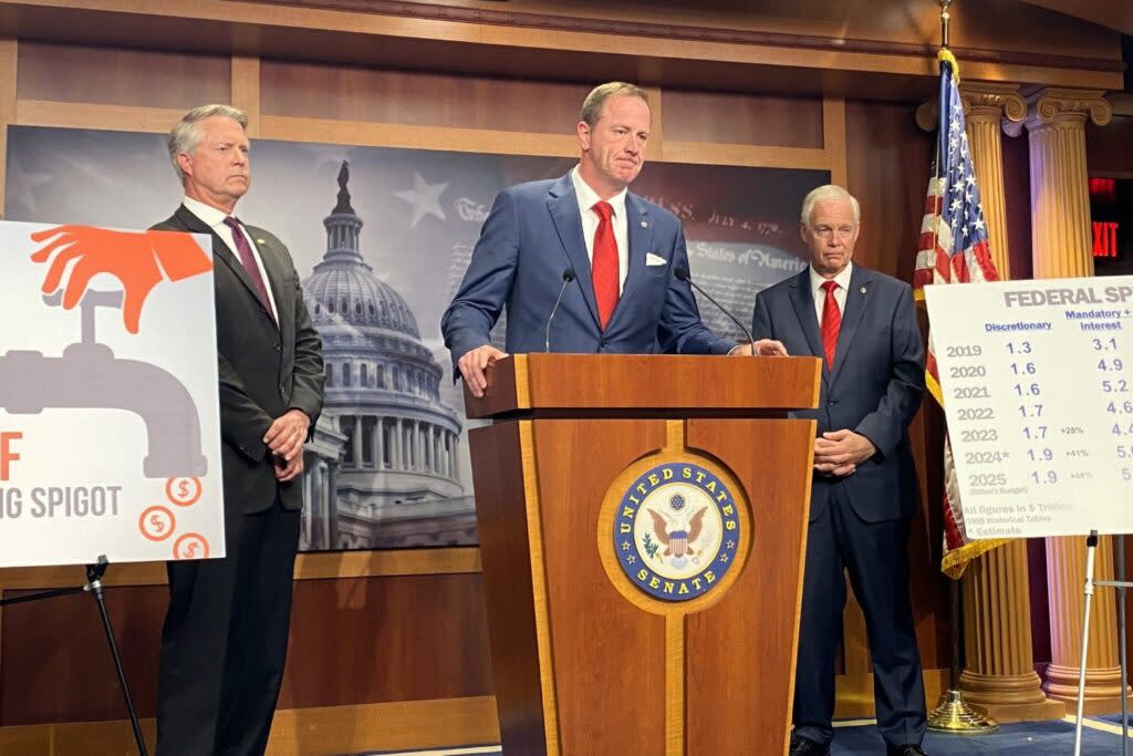 Missouri Republican U.S. Sen. Eric Schmitt speaks during a press conference on Capitol Hill on Wednesday, May 15, 2024. Kansas Republican Sen. Roger Marshall stands at the left and Wisconsin Republican Sen. Ron Johnson is on the right. (Jennifer Shutt/States Newsroom)