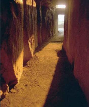 Sunlight illuminates the small room at Newgrange on the winter solstice.