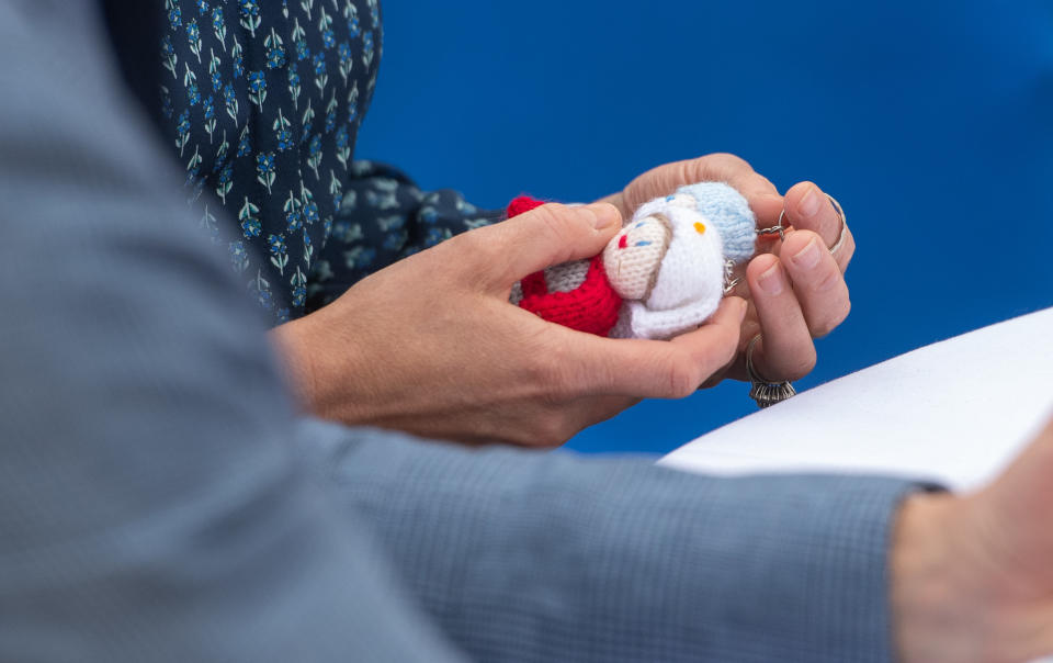 The Duchess of Cambridge holds NHS Knitted Angels during a visit to Queen Elizabeth Hospital in King's Lynn as part of the NHS birthday celebrations.