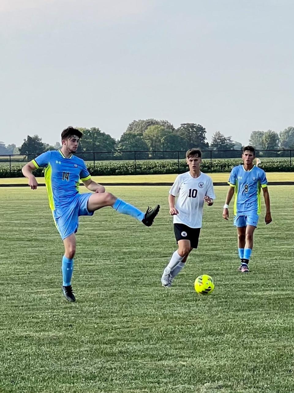 River Valley's Briley Beckley kicks the ball during a boys soccer match at home with Marion Harding as RV's Gabe Dounce and Harding's Jackson Shipley chase the play earlier this season.