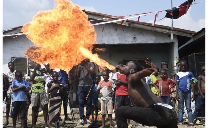 A showman performs with fire