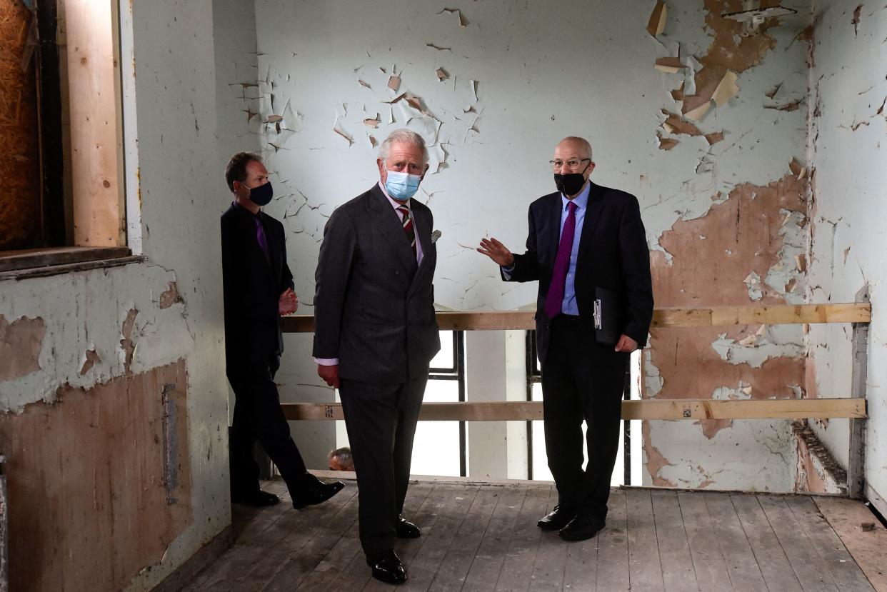 Britain's Prince Charles, Prince of Wales (C), wearing a face covering due to Covid-19, visits the former Merthyr Tydfil Synagogue in Merthyr Tydfil, on May 14, 2021, during his day-long visit to Wales. (Photo by REBECCA NADEN / POOL / AFP) (Photo by REBECCA NADEN/POOL/AFP via Getty Images)