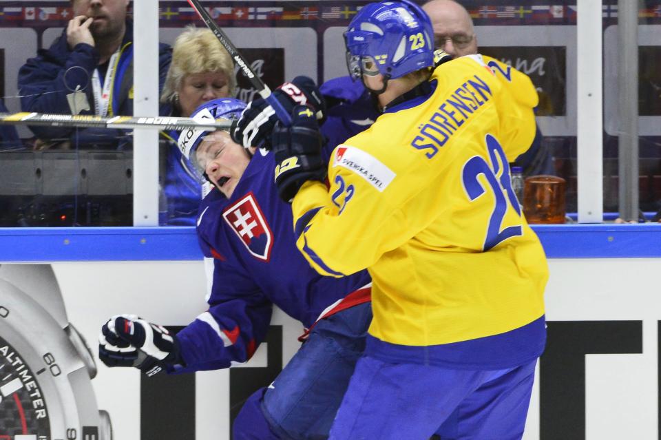 Sweden's Nick Sorensen, right, tackles Slovakia's David Griger during the World Junior Hockey Championships quarter final between Sweden and Slovakia at the Malmo Arena in Malmo, Sweden, on Thursday, Jan. 2, 2014. (AP Photo / TT News Agency, Ludvig Thunman) SWEDEN OUT