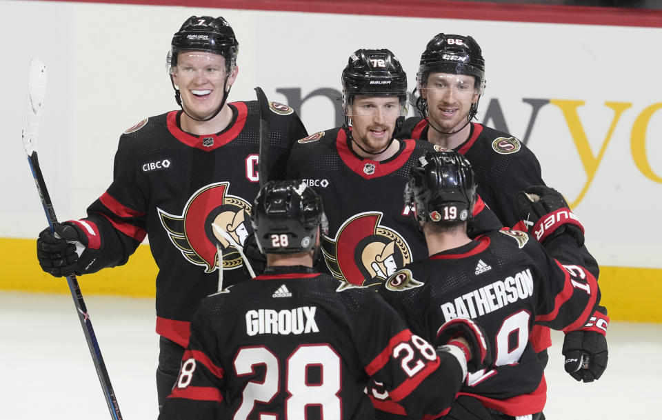 Ottawa Senators defenseman Thomas Chabot (72) celebrates his tying goal with teammates Brady Tkachuk, Claude Giroux, Jake Sanderson and Drake Batherson with 1:05 left in third-period NHL hockey game action against the Montreal Canadiens in Ottawa, Ontario, Saturday, April 13, 2024. (Adrian Wyld/The Canadian Press via AP)