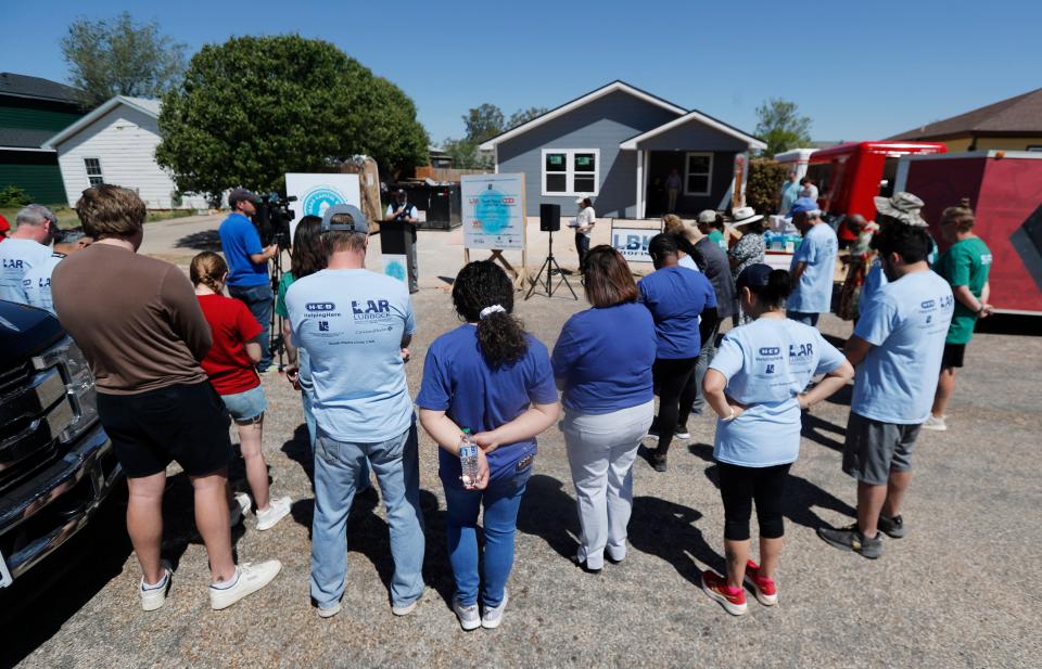 Volunteers gather to say a prayer before the event. Lubbock Habitat for Humanity unveiled their Lubbock Capitol Build on Saturday, April 13, 2024.