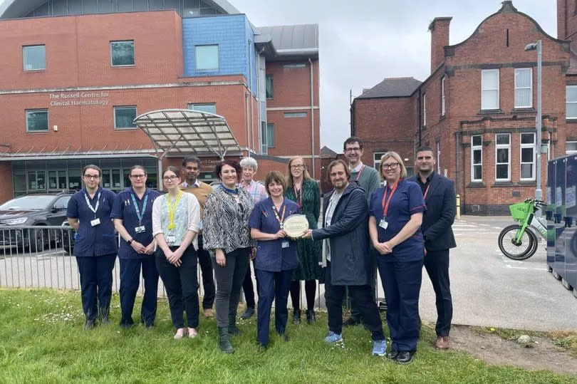 Mr Caulfield, second right, front row, is pictured with the Nottingham City hospital team and the award