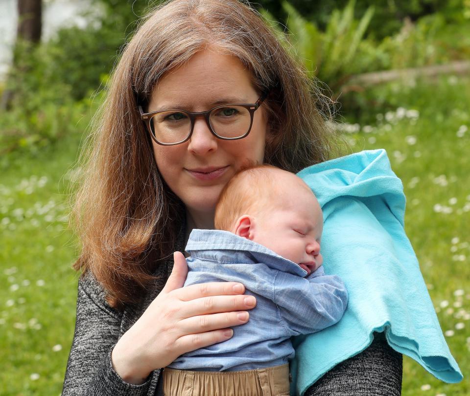 Leanne Wetzel burps son Charlie at Bainbridge Island's Waterfront Park on May 19.