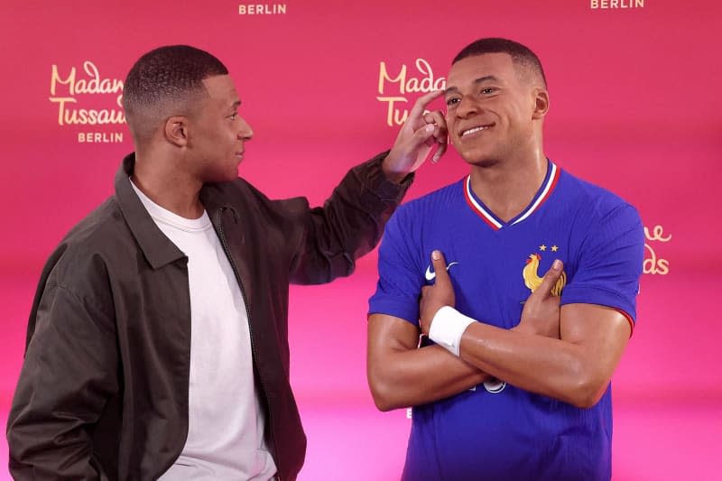 Paris Saint-Germain's Kylian Mbappe poses as he unveils his one-of-a-kind wax figure. A wax figure of the 2018 world champion is coming to Madame Tussauds in the German capital. Franck Fife/AFP/dpa