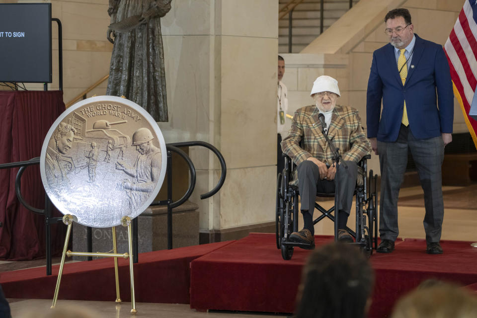 Bernard Bluestein of Hoffman Estates, Ill., seated, speaks during a ceremony to honor him and fellow members of the Ghost Army, secretive WWII-era unit, with the Congressional Gold Medal on Capitol Hill, Thursday, March 21, 2024, in Washington. (AP Photo/Mark Schiefelbein)