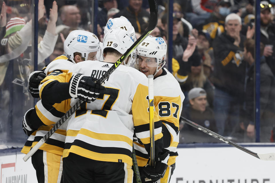 Pittsburgh Penguins players celebrate their goal against the Columbus Blue Jackets during the third period of an NHL hockey game Sunday, Feb. 27, 2022, in Columbus, Ohio. (AP Photo/Jay LaPrete)