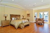 <p>Another one of the bedrooms. This one boasts wood floors and high ceilings. (Realtor.com) </p>