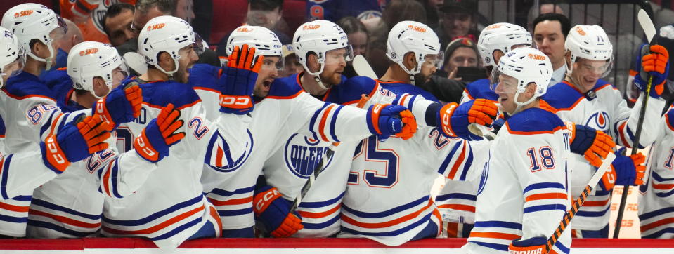 Edmonton Oilers left wing Zach Hyman (18) celebrates a goal with teammates on the bench during the second period of an NHL hockey game against the Ottawa Senators in Ottawa on Saturday, Feb. 11, 2023. (Sean Kilpatrick/The Canadian Press via AP)