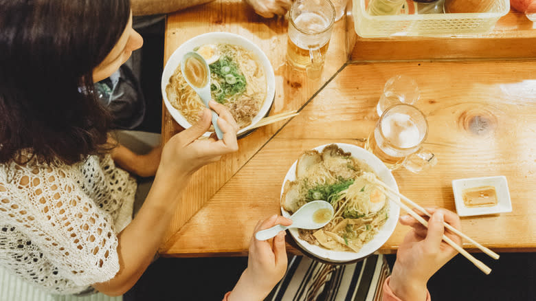 People eating ramen at restaurant