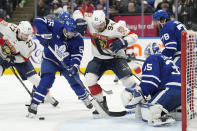 Toronto Maple Leafs defenseman Mark Giordano (55) and Florida Panthers left wing Ryan Lomberg (94) battle for the puck in front of Maple Leafs goaltender Ilya Samsonov (35) during the third period of an NHL hockey game in Toronto on Monday, April 1, 2024. (Frank Gunn/The Canadian Press via AP)