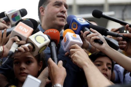 Julio Borges, president of the National Assembly and lawmaker of the Venezuelan coalition of opposition parties (MUD), makes declarations to the media as his children Sofia and Juan Pablo look on after casting his vote in a polling station during a nationwide election for new governors in Caracas, Venezuela, October 15, 2017. REUTERS/Ricardo Moraes