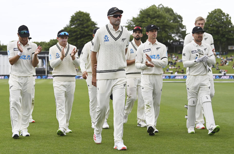 New Zealand players leave the field led by Tim Southee, center, after dismissing the West Indies for 138 runs during play on day three of their first cricket test in Hamilton, New Zealand, Saturday, Dec. 5, 2020. (Andrew Cornaga/Photosport via AP)