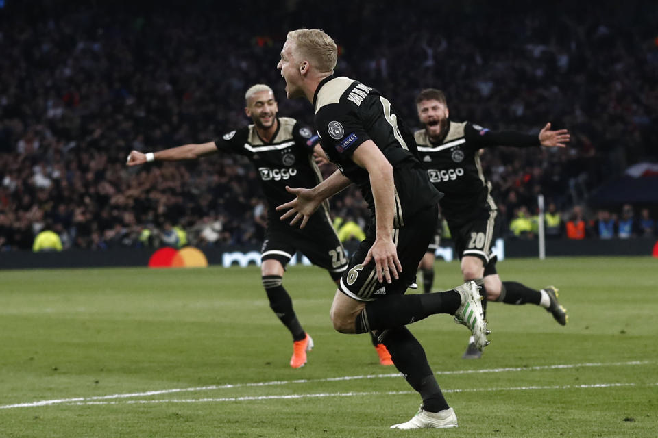 Ajax's Dutch midfielder Donny van de Beek (C) runs to celebrate with teammates after scoring the opening goal of the UEFA Champions League semi-final first leg football match between Tottenham Hotspur and Ajax at the Tottenham Hotspur Stadium in north London, on April 30, 2019. (Photo by Adrian DENNIS / AFP)        (Photo credit should read ADRIAN DENNIS/AFP/Getty Images)