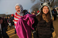 Susannah Ward (L) and Daniela Zara and others gather near the U.S. Capitol building on the National Mall for the Inauguration ceremony on January 21, 2013 in Washington, DC. U.S. President Barack Obama will be ceremonially sworn in for his second term today. (Photo by Joe Raedle/Getty Images)