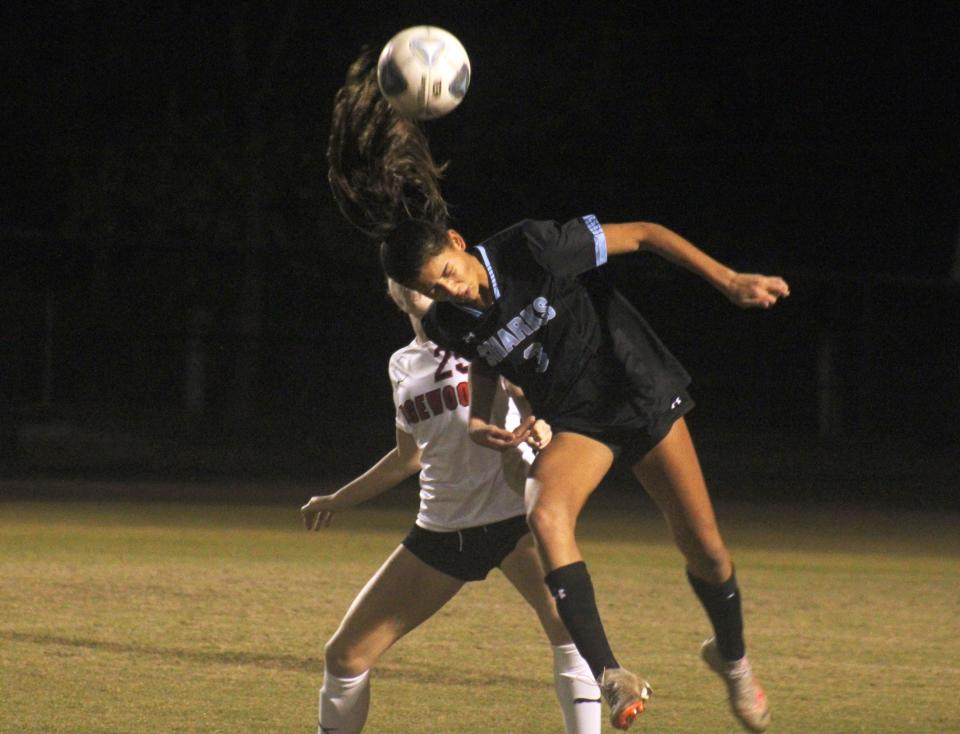 Ponte Vedra defender Lulu Consunji (3) heads the ball away from Edgewood midfielder Bella Bolin (23) in a high school girls soccer game on December 15, 2023. [Clayton Freeman/Florida Times-Union]