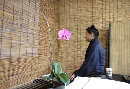 Traditional musician Zhang Chun prepares to perform the "guqin" at an art space in Beijing, China