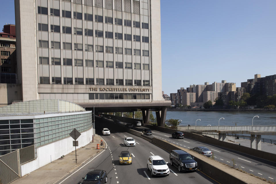 In this Sept. 26, 2019, photo, cars pass Rockefeller University in New York. Prestigious universities around the world, including Rockefeller, have accepted at least $60 million over the past five years from the family that owns the maker of OxyContin, even as the company became embroiled in lawsuits related to the opioid epidemic, financial records show. Rockefeller accepted more money from the Sacklers than any other school in recent history. (AP Photo/Mark Lennihan)