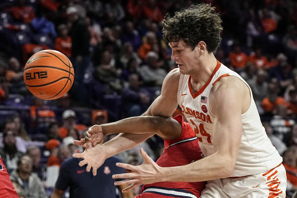 Clemson center PJ Hall (24) loses the ball against Radford guard Kenyon Giles during the first half of an NCAA college basketball game, Friday, Dec. 29, 2023, in Clemson, S.C. (AP Photo/Mike Stewart)