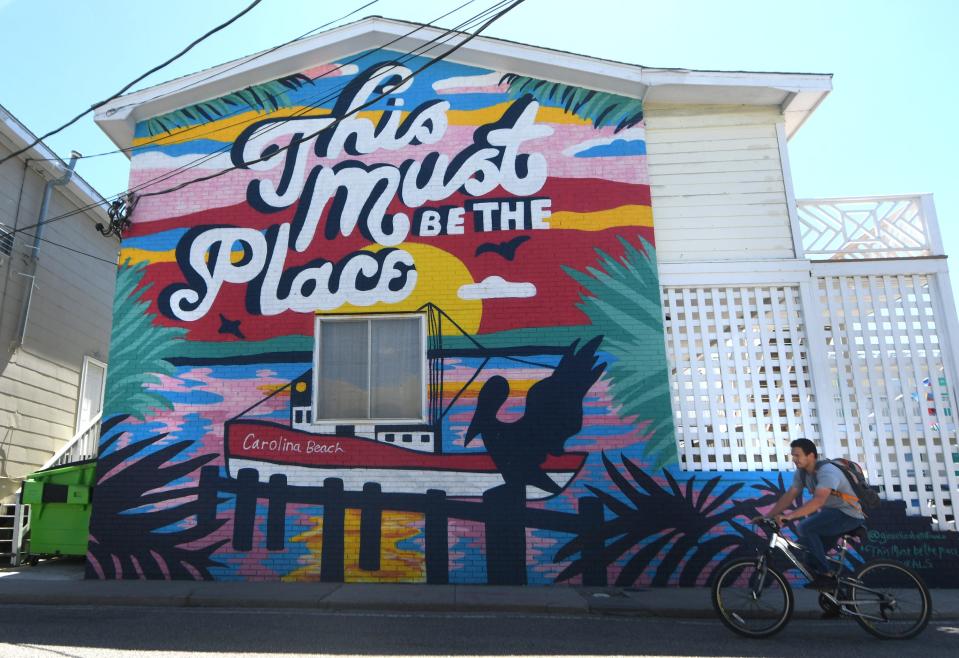 The "This Must Be the Place" mural on the side of the Savannah Inn at 316 Carolina Beach Ave. is one of the numerous murals throughout Carolina Beach.     [MATT BORN/STARNEWS]