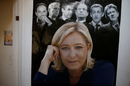 A poster of Marine Le Pen is seen on a wall at her local headquarters in Henin-Beaumont, France, April 6, 2017. REUTERS/Pascal Rossignol