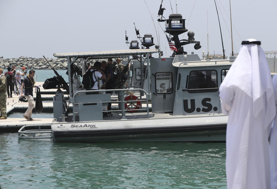 Journalists board a U.S. Navy patrol boat at the U.S. Navy 5th Fleet base, during a trip organized by the Navy for journalists, near Fujairah, United Arab Emirates, Wednesday, June 19, 2019. Cmdr. Sean Kido of the U.S. Navy's 5th Fleet said Wednesday that the limpet mine used on a Japanese-owned oil tanker last week "bears a striking resemblance" to similar Iranian mines. (AP Photo/Kamran Jebreili)