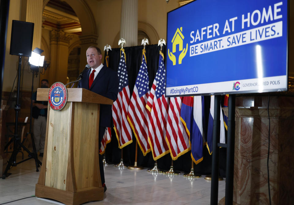 Colorado Gov. Jared Polis makes a point during a news conference to update the state's efforts to check the spread of the new coronavirus Monday, May 11, 2020, in Denver. Polis announced that a restaurant in Castle Rock, Colo., that opened Sunday in defiance of state rules barring in-person dining will have its business license suspended temporarily for the action. (AP Photo/David Zalubowski)