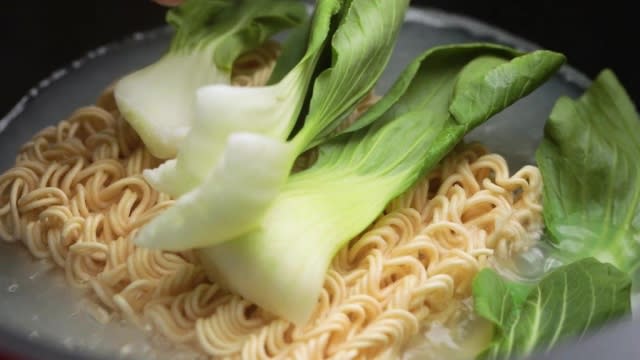 Boiling instant noodles with bok choy