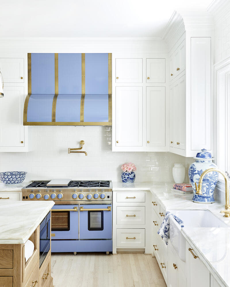 A playful periwinkle hood pops in this white kitchen by Wilson