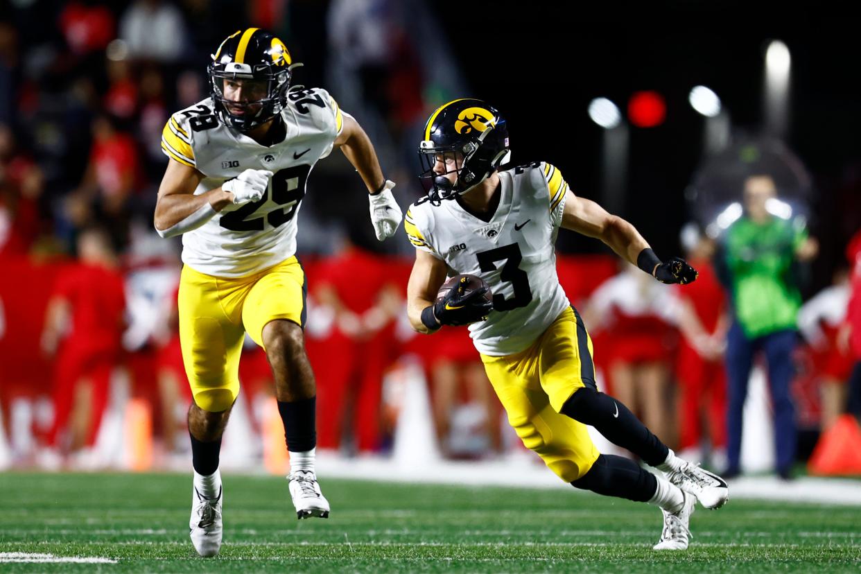 Iowa defensive back Cooper DeJean intercepts a pass and returns it for a touchdown against Rutgers.