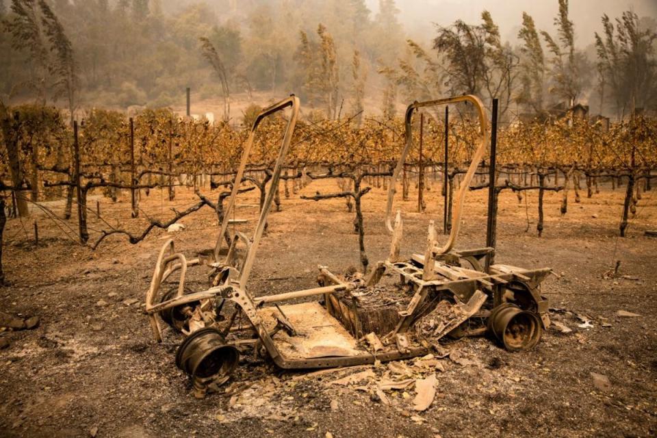 The remains of a golf cart burned by the Glass Fire sits next to a vineyard at Calistoga Ranch in Calistoga, Napa Valley, California on September 30, 2020 (AFP via Getty Images)