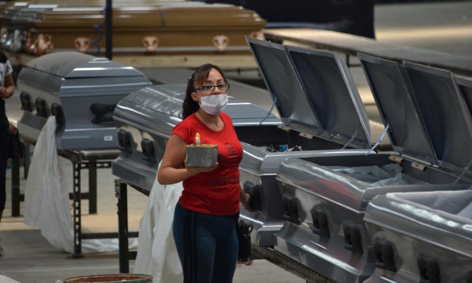 A worker wears a face mask in a factory in Mexico City making coffins designed to b hermetically sealed to transport corpses of people who died from Covid-19.