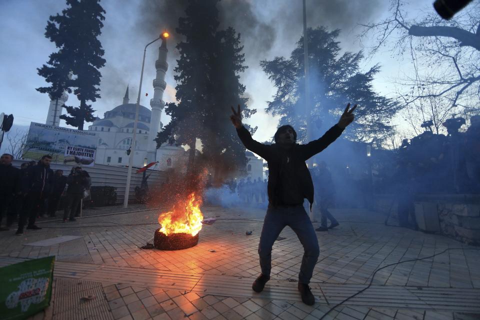 A protester flashes the V-victory sign during an anti-government rally in Tirana, Tuesday, Feb. 26, 2019. Albania’s parliament has decided to hold its plenary session on Tuesday and not two days later apparently to avoid a confrontation with the opposition supporters’ rally. (AP Photo/Hektor Pustina)