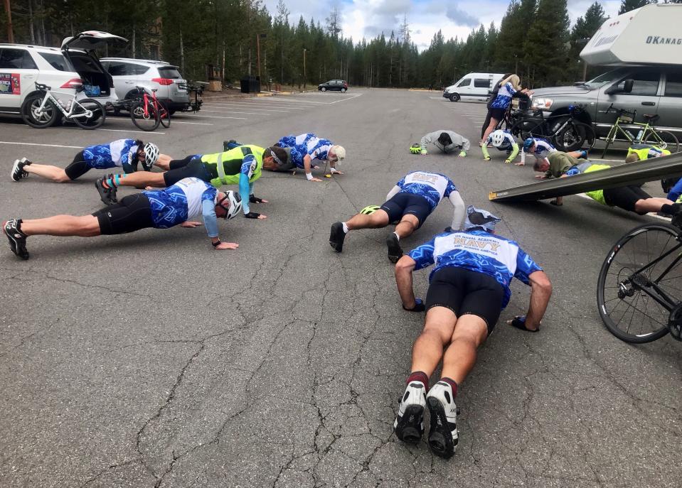 Members of the U.S. Naval Academy class of 1983 ride start each day's cycling with 22 pushups to raise awareness of veteran suicides, as seen here in Wyoming. Their cross-country ride will stop in South Bend the night of Sept. 24, 2023.