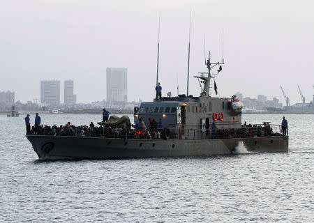 Migrants arrive by boat at a naval base after they were rescued by Libyan coastguard, in the coastal city of Tripoli, Libya, May 26, 2017. REUTERS/Hani Amara