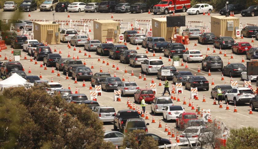 LOS ANGELES, CA - JULY 08: Testing continues Wednesday July 8, 2020 at Dodgers Stadium as drivers with an appointment continue in the queue for Coronavirus Covid-19 testing which has resumed at Dodger Stadium this week with a new drive-through testing. Dodger Stadium on Wednesday, July 8, 2020 in Los Angeles, CA. (Al Seib / Los Angeles Times)