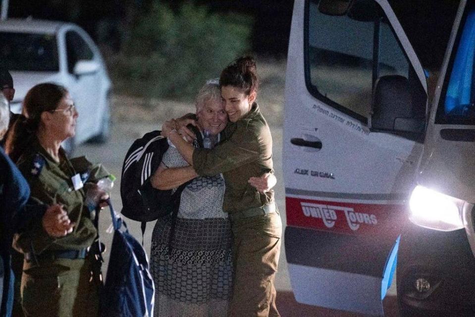Margalit Mozes, a released Israeli hostage, walks with an Israeli soldier shortly after her arrival in Israel on Friday, Nov. 24, 2023. A four-day cease-fire in the Israel-Hamas war began in Gaza on Friday with an exchange of hostages and prisoners.