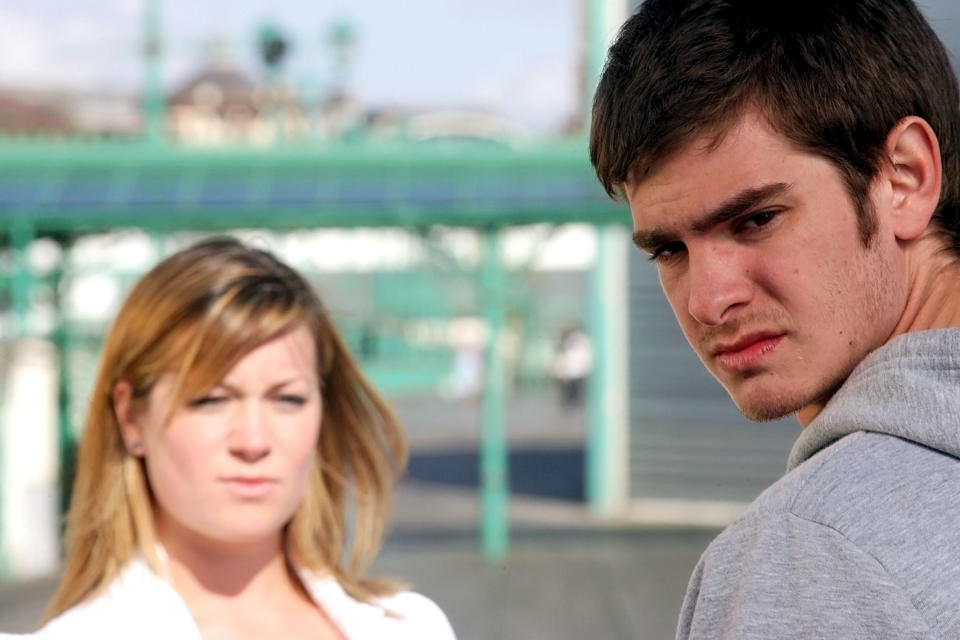 Katie Lyons and Andrew Garfield look at the camera