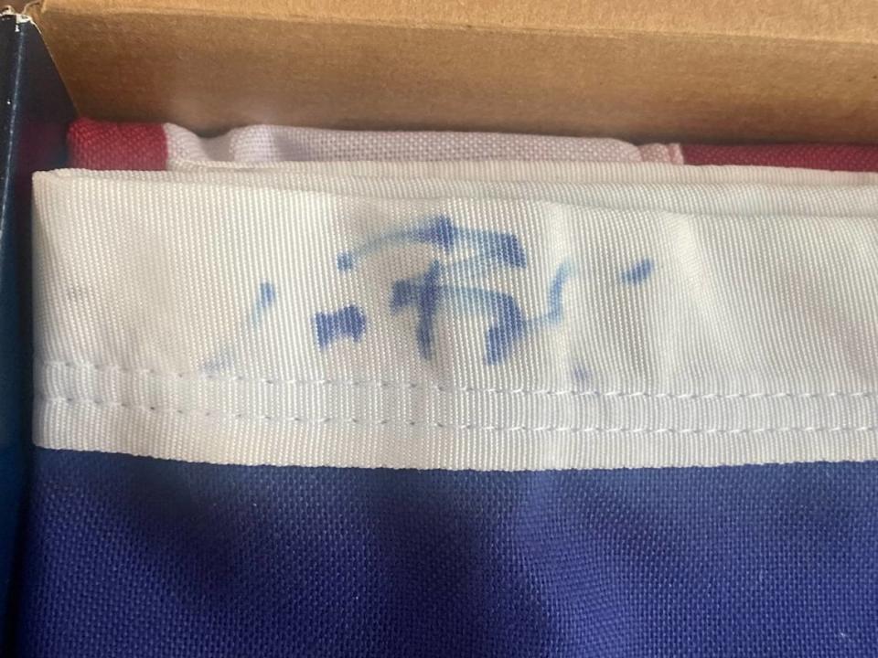 This provided photo shows Vitale’s flag, with Tom Brady’s signature faded.